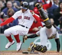  ?? CHARLES KRUPA — THE ASSOCIATED PRESS ?? Pittsburgh Pirates catcher Chris Stewart, right, tags out Boston Red Sox’s Mookie Betts while trying to score during the eighth inning Thursday.