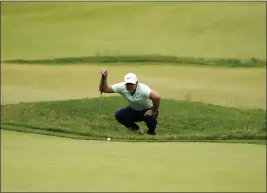  ?? CHARLES KRUPA — THE ASSOCIATED PRESS ?? Brooks Koepka prepares to putt on the fourth hole during the third round of the U.S. Open at The Country Club, Saturday in Brookline, Mass.