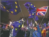  ?? AP/FRANK AUGSTEIN ?? Anti-Brexit demonstrat­ors react Tuesday after the results of the vote on British Prime Minister Theresa May’s deal were announced in Parliament square in London.