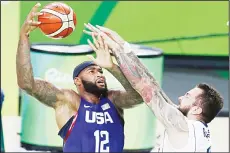  ??  ?? United States’ DeMarcus Cousins (12) is fouled by Serbia’s Miroslav Raduljica (13) during the men’s gold medal basketball game at the 2016 Summer Olympics in Rio de Janeiro, Brazil on Aug 21. (AP)