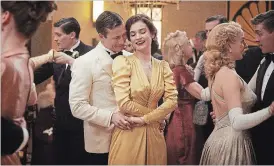  ?? KERRY BROWN NETFLIX ?? Glen Powell and Lily James in “The Guernsey Literary and Potato Peel Pie Society.”