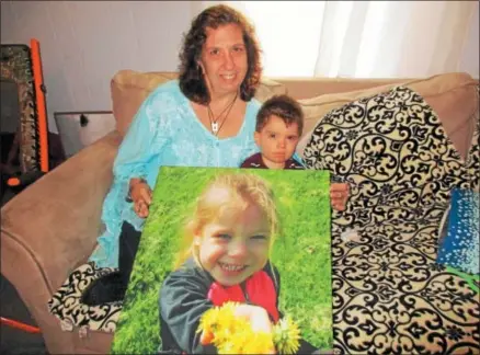  ?? PHOTO SPECIAL TO THE DISPATCH BY MIKE JAQUAYS ?? Colleen Skinner and grandson Isaac Dickerman, 2, hold a photo of Isaac’s sister Lilly at Skinner’s Oneida home on May 8. Skinner is organizing the first annual Lilly’s Dance Angels Walk-a-thon coming up on Saturday, May 19in Allen Park.