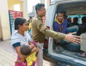  ?? ANUPAM NATH/AP ?? Nureja Khatun asks police to release her husband, waiting inside the van to go to court Feb. 11, in Morigaon district of India’s state of Assam.