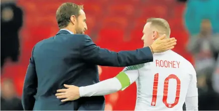  ?? Photo / Photosport ?? Wayne Rooney shares an embrace with coach Gareth Southgate after his one-off return to the England team.