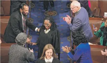  ?? JIM WATSON/AFP VIA GETTY IMAGES ?? Justice Ketanji Brown Jackson (middle) is greeted while arriving for the State of the Union address in the House Chamber of the Capitol on Feb. 7.