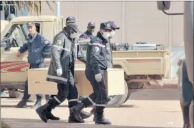  ?? ANIS BELGHOUL/ THE ASSOCIATED PRESS ?? Algerian firefighte­rs carry a coffin containing a person killed during the gas facility hostage situation on Monday. In all, 38 workers and 29 militants died.