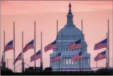  ?? AP PHOTO/J. DAVID AKE ?? Flags flying a half-staff in honor of Sen. John McCain, R-Ariz., frame the U.S. Capital at daybreak in Washington, Sunday, Aug. 26, 2018.