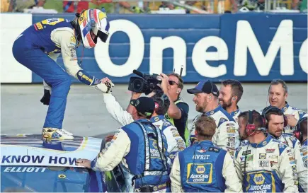  ?? JARED C. TILTON/GETTY IMAGES ?? Chase Elliott celebrates with his team Sunday after winning the Gander Outdoors 400 at Dover Internatio­nal Speedway to ensure he’ll move on to the third round of the Monster Energy NASCAR Cup Series playoffs.