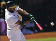  ??  ?? The Athletics’ Elvis Andrus hits a double to drive in a run against the Tampa Bay Rays during the eighth inning Saturday.