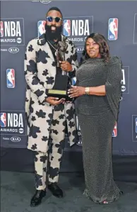  ?? RICHARD SHOTWELL / INVISION / AP ?? James Harden of the Houston Rockets poses with his Most Valuable Player award alongside his mother, Monja Willis, at the NBA Awards at the Barker Hangar in Santa Monica, California, on Monday.