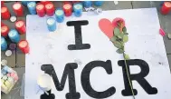 ??  ?? Shrine Tributes pile up in Manchester city centre