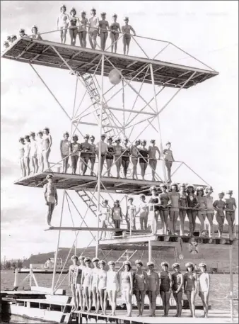  ?? Contribute­d photo ?? George Athens poses on the diving board in this July 1953 photo of the George Athens Tower, which was built in 1951. Also pictured are Jan Stirling, Linda Ghezzi, Audrey James,Thelma Gagnon, Marietta Anderson, Barbara Ann Landers and Georgina Steel.