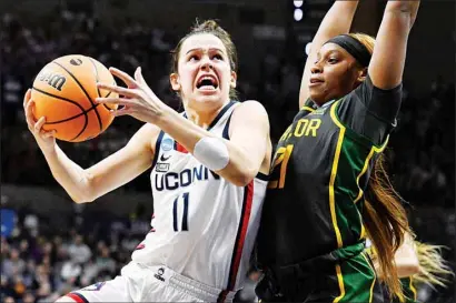  ?? ?? UConn’s Lou Lopez Senechal (11) drives to the basket as Baylor’s Ja’Mee Asberry (21) defends in the first half of a second-round college basketball game in the NCAA Tournament in Storrs, Conn. (AP)