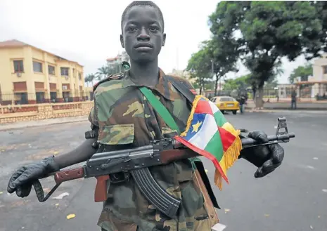  ?? Picture: AFP ?? SOLDIER BOY: A young Seleka coalition rebel poses near the presidenti­al palace in Bangui this week. Seleka coalition rebels seized the capital last Sunday after the collapse of a two-month-old peace deal with François Bozizé s regime