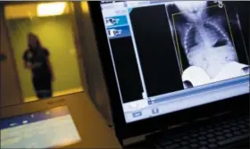  ?? DAVID GOLDMAN — THE ASSOCIATED PRESS ?? A radiology technician looks at a chest X-ray of a child suffering from flu symptoms at Upson Regional Medical Center in Thomaston, Ga., Friday.