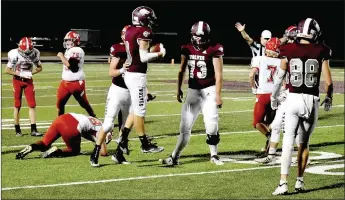  ?? MARK HUMPHREY ENTERPRISE-LEADER ?? Lincoln players celebrate a key intercepti­on by senior Marcus Sturgill that ended the Tigers’ first possession on fourth-and-2 from the Wolves’ 14. Lincoln went on to record a 41-14 Homecoming victory Friday at Wolfpack Stadium.