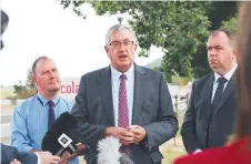  ?? Picture: LUKE BOWDEN ?? MOVING FORWARD: Transport Minister Rene Hidding, centre, announces the Liberals’ road pledge.