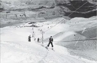  ?? PHOTO: LAKES DISTRICT MUSEUM ?? Hold on . . . Skiers use the Hamilton rope tow at Coronet Peak during its first years as a commercial skifield.