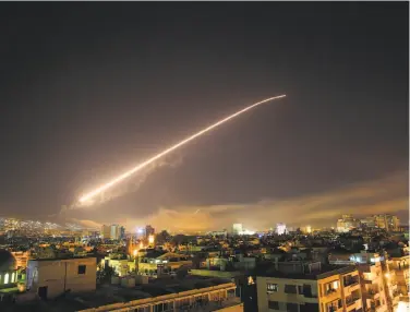  ?? Hassan Ammar / Associated Press ?? Missile fire lights up the Damascus sky as the U.S. begins an attack on Syria targeting parts of the capital. President Trump announced air strikes in retaliatio­n for Bashar Assad’s alleged use of chemical weapons.