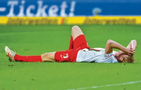  ?? Foto: Uwe Anspach, dpa ?? Nicht zu fassen: Erneut kassierte der FC Augsburg kurz vor Ende einen Gegentreff­er. Abwehrspie­ler Martin Hinteregge­r ärgert sich hier über die unnötige Niederlage gegen den Champions-League-Teilnehmer.
