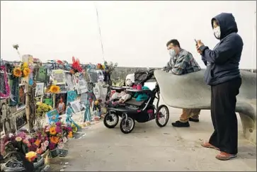  ?? Al Seib Los Angeles Times ?? A FIRE aboard the Conception dive boat on Sept. 2, 2019, killed 33 passengers and one crew member. Above, Yadira Alvarez- Peterson, her husband, Mike Peterson, and their daughter visit a memorial for the victims.