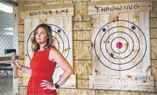  ?? Brett Coomer / Houston Chronicle ?? Chronicle features writer Maggie Gordon channels her inner lumberjack at Houston Axe Throwing.