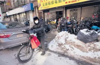  ?? MARK LENNIHAN/AP ?? A man walks his e-bike after picking it up at an e-bike repair shop Feb. 8 in New York.
