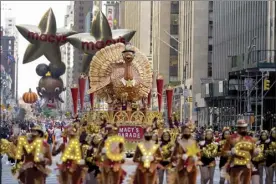  ?? AP photo ?? The Tom Turkey float moves down Sixth Avenue during the Macy's Thanksgivi­ng Day Parade in New York on Thursday. The parade is returned in full, after being crimped by the coronaviru­s pandemic last year.
