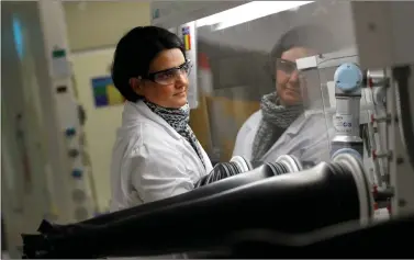  ??  ?? A scientist uses a molecular weighing robot during research at the Glaxosmith­kline research centre in Britain , on Tuesday. REUTERS