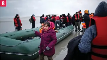  ?? ?? A young girl, wrapped up against the chill, watches as the dinghy is made ready