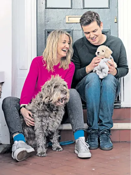  ??  ?? Gavin Newsham with his wife and dogs at home in Brighton; and at the park, below