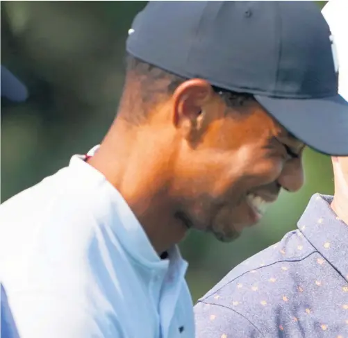  ??  ?? Friendly rivalry: Tiger Woods shares a lighter moment with Rory Mcilroy