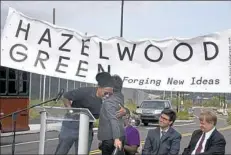  ?? Darrell Sapp/Post-Gazette ?? The Rev. Tim Smith, CEO of Center of Life and pastor of the Keystone Church of Hazelwood, hugs Rebecca Flora, president and CEO of ReMake Group and Almono LLC project director, at the announceme­nt Friday of the new name for the Almono site in...