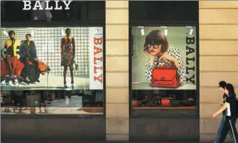  ?? BLOOMBERG VIA GETTY IMAGES ?? Pedestrian­s walk past a Bally Internatio­nal AG store in Sydney, Australia.