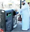  ??  ?? An official uses the electronic garbage box, which has a smart solar-powered waste recycling system, at Al Mamzar Park.