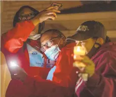  ??  ?? Aiden’s mother Claudette Pottinger, center, cries during the vigil.