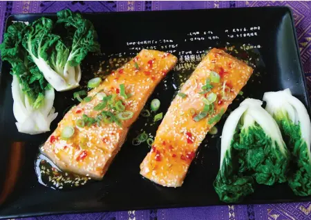  ??  ?? Steelhead fillets are flavoured with sweet Thai chili sauce and served with steamed baby bok choy.