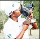  ??  ?? Sebastian Munoz, of Colombia, kisses the trophy after winning the Sanderson Farms Championsh­ip golf tournament in Jackson, Mississipp­i
on Sept 22. (AP)