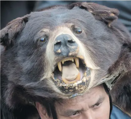  ?? — THE CANADIAN PRESS FILES ?? Thomas Terry of the St’at’imc First Nation wears a black bear hide during a protest against the Kinder Morgan Trans Mountain pipeline expansion.