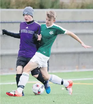  ??  ?? Royal Bay Ravens’ Jaden Jeske, left, fights for the ball with Oak Bay’s Leif St. Bright during the Colonist Cup semifinals on the Oak Bay turf field on Tuesday.