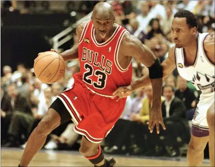  ?? MIKE NELSON — AFP VIA GETTY IMAGES ?? Michael Jordan was the focal point of the Chicago Bulls during the 1997-98season, when they reached Beatlemani­a-level popularity.