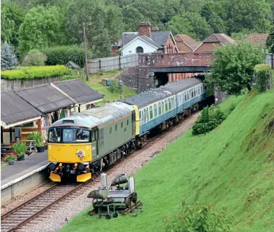  ??  ?? Visiting the Spa Valley Railway for its summer diesel event was South Devon Diesel Traction’s recently repainted 33002 Sea Lion, with the Class 33 due to remain on the SVR until October. On August 6, 33002 arrives at Groombridg­e station with the 11:00 Tunbridge Wells to Eridge service, with 33002 hauling preserved 3CIG 1497, which was in use as hauled stock during the event. Phil Barnes