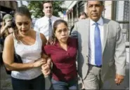  ?? CRAIG RUTTLE — ASSOCIATED PRESS ?? Yeni Gonzalez, center, arrives to be reunited with her children in New York on Tuesday.