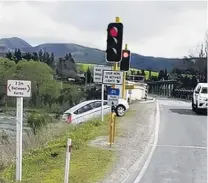  ?? PHOTO: BLAIR POWELL ?? Oops . . . The moment a vehicle rolled down a bank after reversing out of the onelane bridge at Beaumont on Friday.