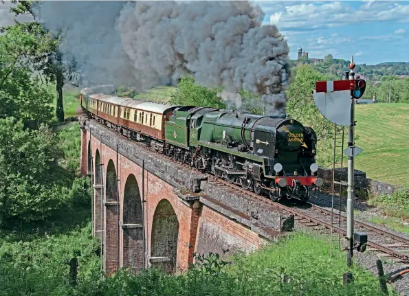  ?? JOHN TITLOW ?? Hauling the start of the return leg of a Belmond Pullman private charter visiting the Severn Valley Railway, Bulleid West Country Pacific No. 34027 Taw Valley, fully bedecked with ‘Golden Arrow' regalia, crosses Oldbury Viaduct on June 5.