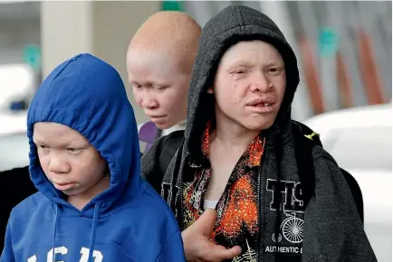  ?? PHOTO: REUTERS ?? Mwigulu Magesa, left, Pendo Noni, centre, and Emmanuel Rutema, Tanzanians with albinism visiting the US for medical care, arrive at JFK Internatio­nal Airport in New York City.