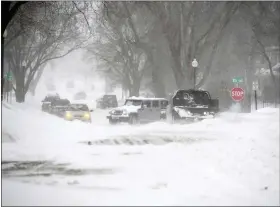  ?? ERIN WOODIEL — THE ARGUS LEADER VIA AP ?? Vehicles are stuck during a snowstorm Wednesday in Sioux Falls, S.D.