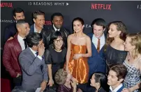  ?? 13 Reasons Why AFP ?? Actress/singer Selena Gomez surrounded by cast members as they arrive for the premiere Of Netflix’s at Paramount Pictures Studio in Los Angeles, California. —