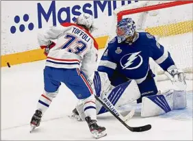  ?? Mike Ehrmann / Getty Images ?? Tampa Bay’s Andrei Vasilevski­y deflects a shot by Montreal’s Tyler Toffoli in Game 2. Vasilevski­y finished with a playoff career-high 42 saves.