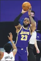  ?? AP photo ?? LeBron James of the Lakers shoots against the Trail Blazers’ Derrick Jones Jr. during Los Angeles’ 102-93 win Friday.